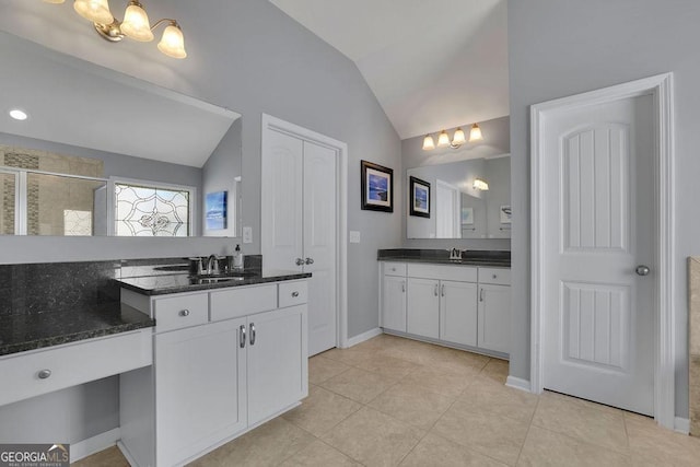 4100 Secret Shoals Way, Buford, GA 30518 - full bath with a chandelier, lofted ceiling, a shower stall, two vanities, and tile patterned floors