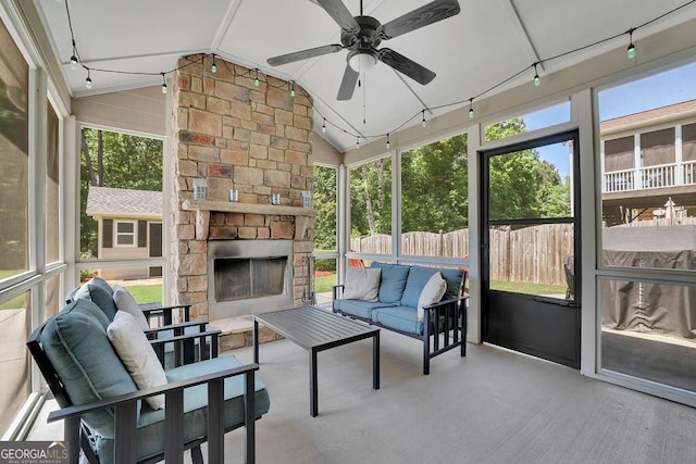 4100 Secret Shoals Way, Buford, GA 30518 - sunroom / solarium with lofted ceiling, a ceiling fan, plenty of natural light, and an outdoor living space with a fireplace