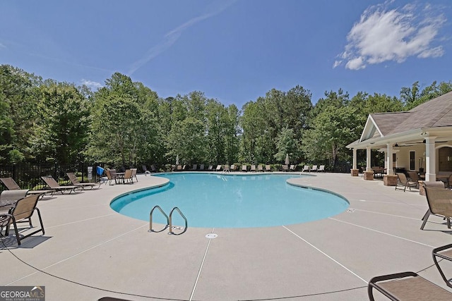 4100 Secret Shoals Way, Buford, GA 30518 - community pool featuring a patio, a ceiling fan, and view of scattered trees