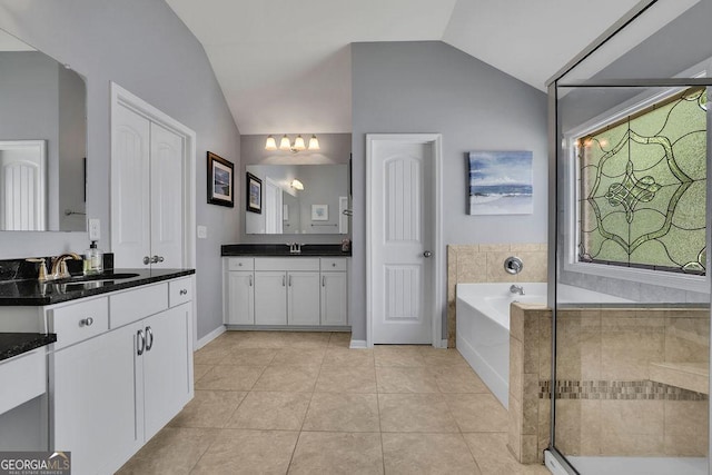 4100 Secret Shoals Way, Buford, GA 30518 - full bathroom featuring lofted ceiling, a bath, vanity, tile patterned flooring, and a chandelier