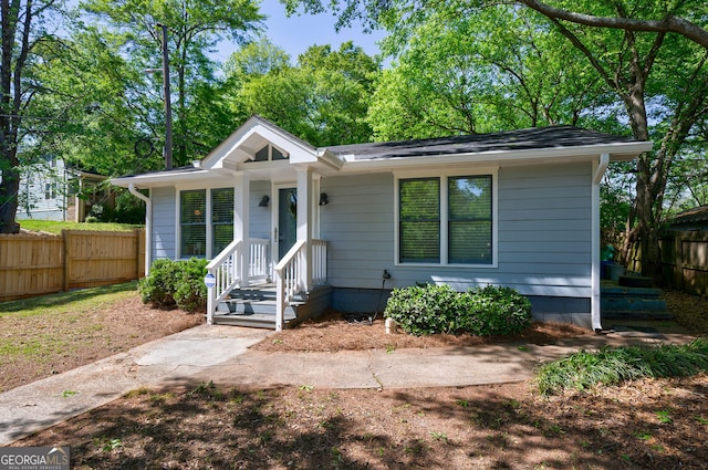 bungalow-style home featuring fence