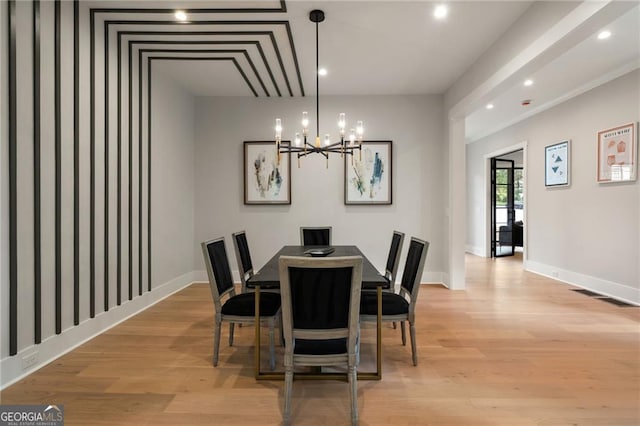 dining space with a chandelier, light wood finished floors, baseboards, and recessed lighting