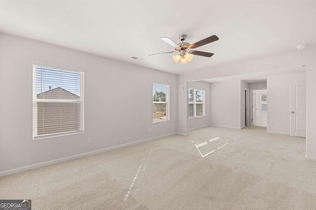 unfurnished bedroom featuring baseboards, light carpet, and a ceiling fan