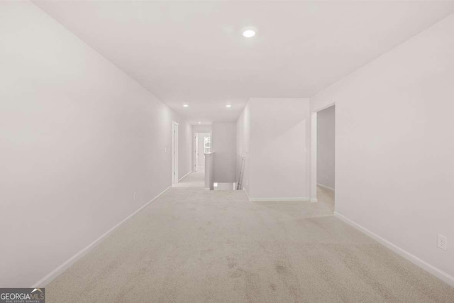 spare room with recessed lighting, baseboards, and carpet