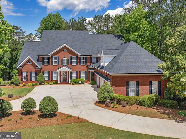 219 Eagles Landing Way, Mcdonough, GA 30253 - colonial house with driveway, brick siding, roof with shingles, and an attached garage