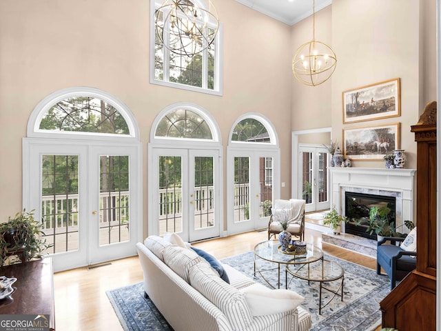 219 Eagles Landing Way, Mcdonough, GA 30253 - living room featuring a chandelier, french doors, a towering ceiling, healthy amount of natural light, and crown molding