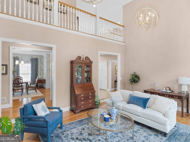 219 Eagles Landing Way, Mcdonough, GA 30253 - living room with a chandelier, wood finished floors, and a high ceiling