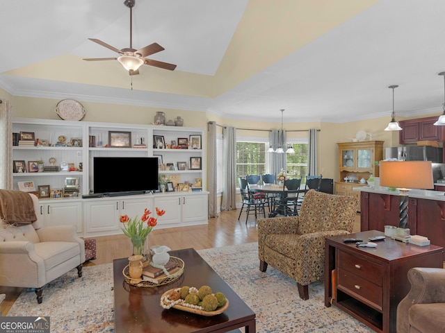 219 Eagles Landing Way, Mcdonough, GA 30253 - living area featuring a raised ceiling, ceiling fan, light wood-style floors, a chandelier, and ornamental molding