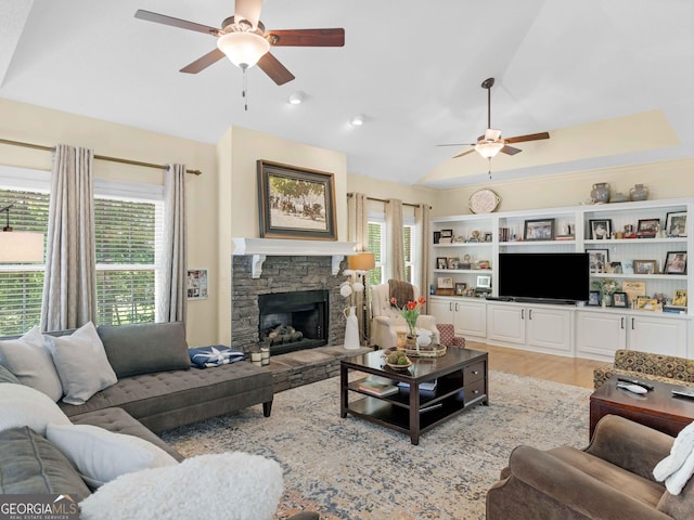 219 Eagles Landing Way, Mcdonough, GA 30253 - living room with ceiling fan, vaulted ceiling, a fireplace, and light wood-style flooring