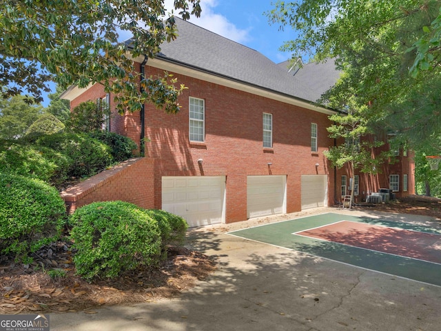 219 Eagles Landing Way, Mcdonough, GA 30253 - view of property exterior with an attached garage, driveway, brick siding, and roof with shingles