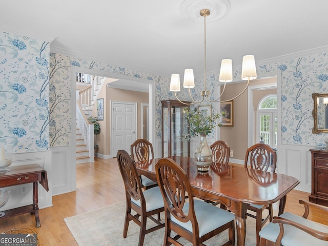 219 Eagles Landing Way, Mcdonough, GA 30253 - dining area with wallpapered walls, wainscoting, stairway, ornamental molding, and light wood-style flooring