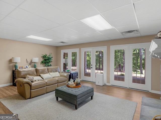 219 Eagles Landing Way, Mcdonough, GA 30253 - living room with a paneled ceiling, wood finished floors, plenty of natural light, and french doors