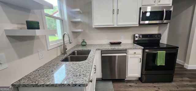 110 Forrest Ave, Jackson, GA 30233 - kitchen featuring appliances with stainless steel finishes, a sink, dark wood finished floors, open shelves, and white cabinets