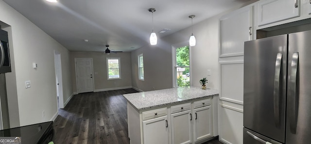 110 Forrest Ave, Jackson, GA 30233 - kitchen featuring freestanding refrigerator, a peninsula, dark wood-type flooring, white cabinetry, and light stone counters