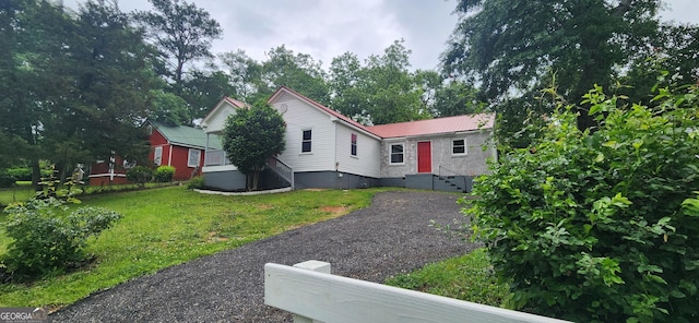 110 Forrest Ave, Jackson, GA 30233 - view of front of house with metal roof and a front lawn