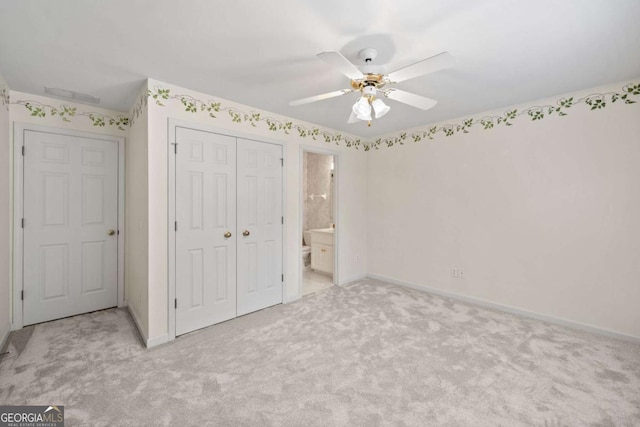 unfurnished bedroom with light colored carpet, a closet, and baseboards