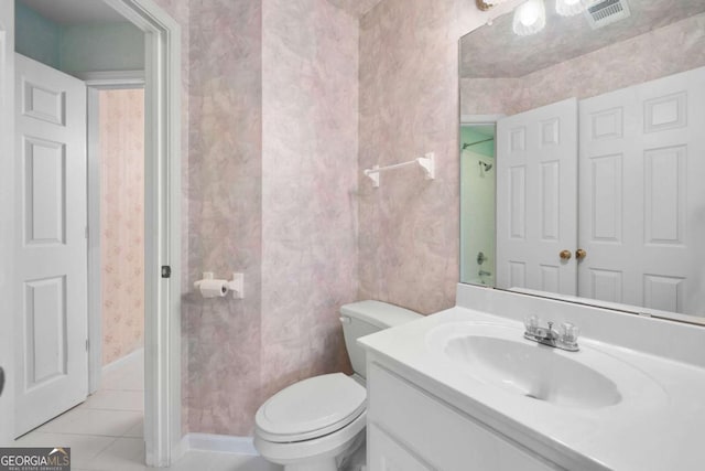 bathroom with tile patterned floors, toilet, vanity, and baseboards