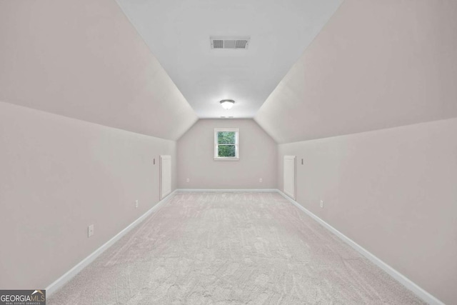 bonus room featuring baseboards, vaulted ceiling, and carpet