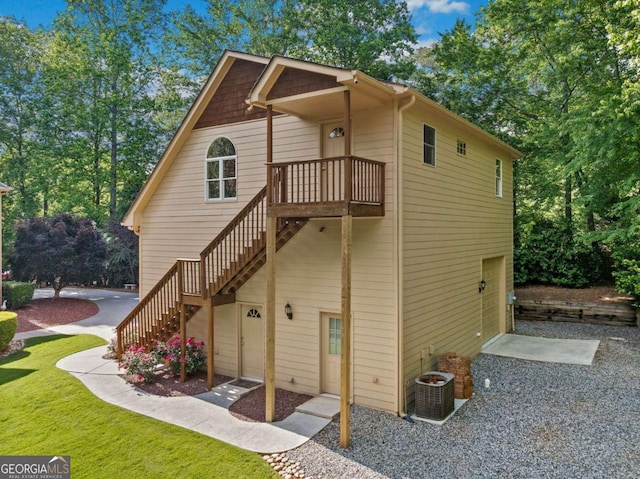back of house featuring stairway and cooling unit
