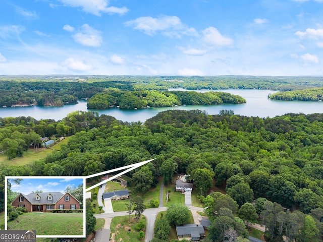 view of property location featuring a heavily wooded area, a large body of water, and property parcel outlined