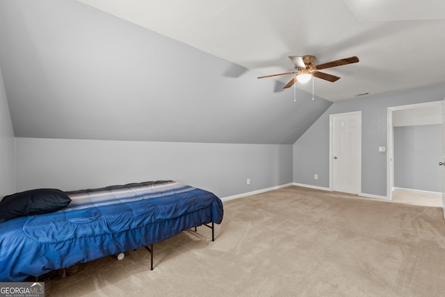 bedroom featuring carpet, baseboards, lofted ceiling, and ceiling fan
