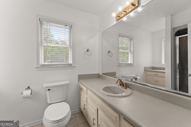 bathroom featuring toilet, vanity, and tile patterned flooring
