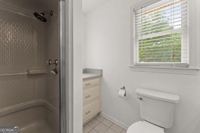 full bathroom with a shower, baseboards, tile patterned flooring, and toilet