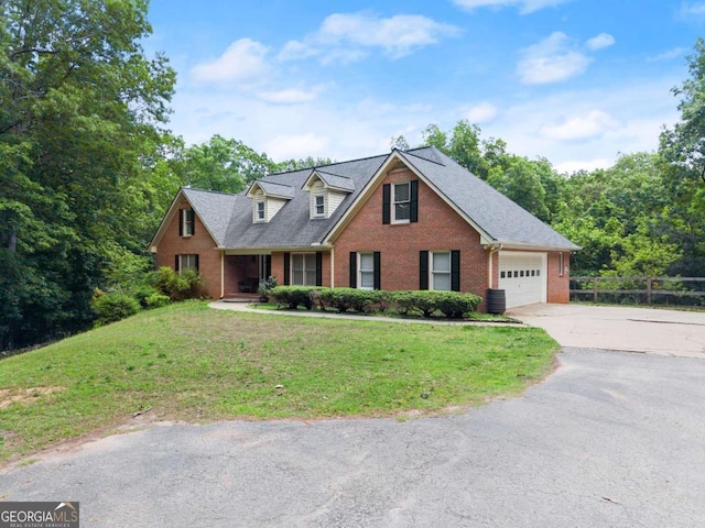 cape cod home with brick siding, driveway, and a garage