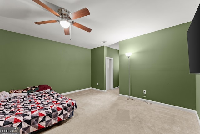 bedroom with light colored carpet, baseboards, and ceiling fan