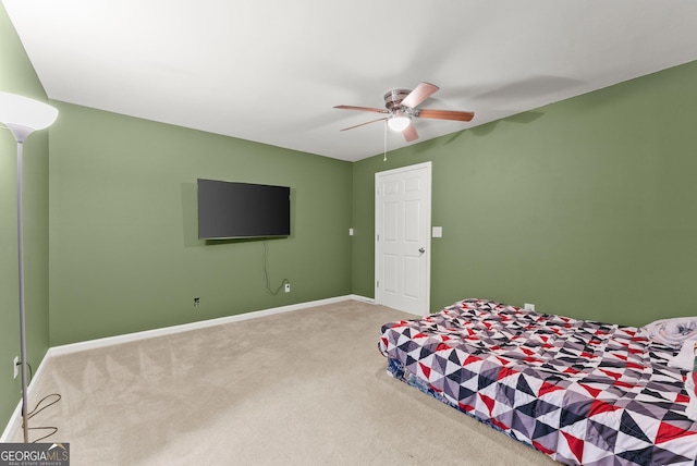 carpeted bedroom with baseboards and a ceiling fan