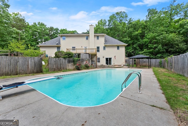 view of swimming pool featuring a fenced backyard, a gazebo, a patio, and a diving board