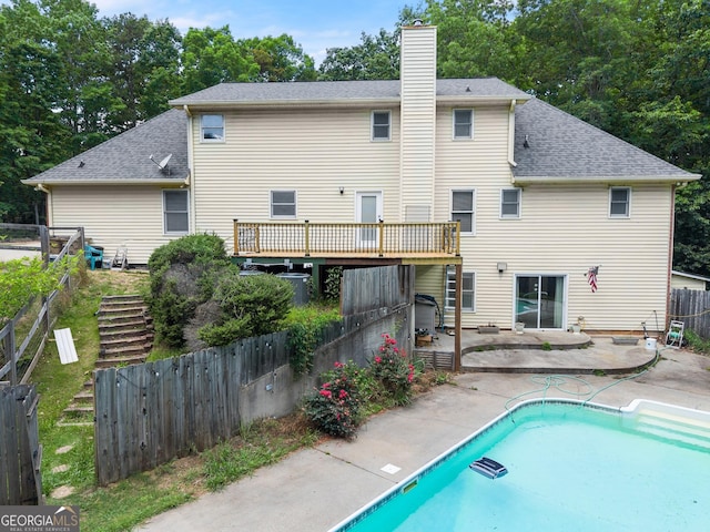 back of house with a patio area, a chimney, fence, roof with shingles, and central air condition unit