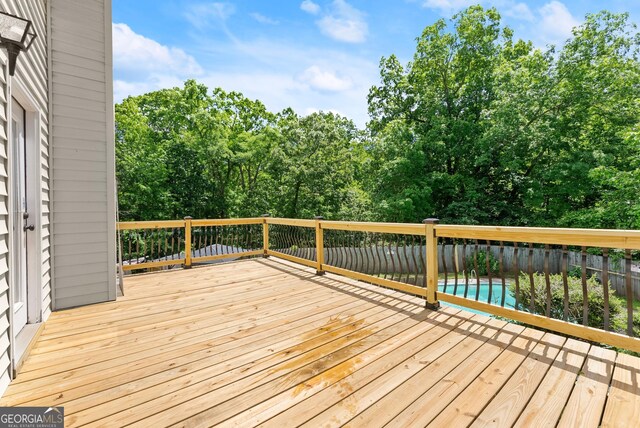 deck featuring view of scattered trees
