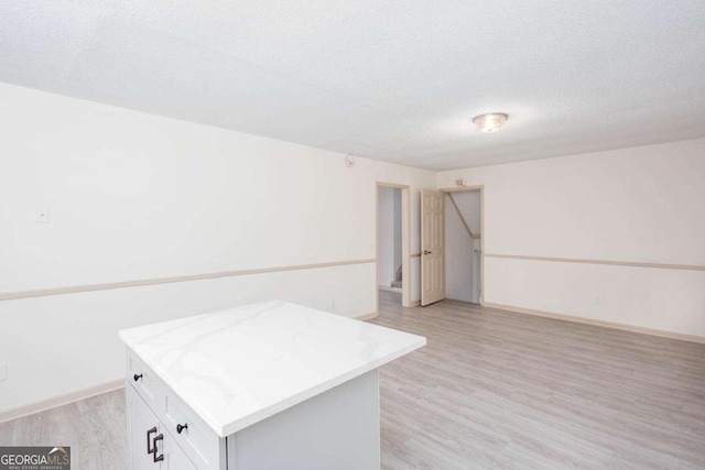 315 Henson Cir, Carrollton, GA 30117 - spare room featuring light wood-type flooring, a textured ceiling, and baseboards