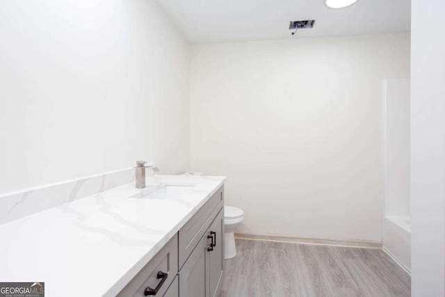 315 Henson Cir, Carrollton, GA 30117 - bathroom featuring vanity, toilet, wood finished floors, a bathtub, and a shower