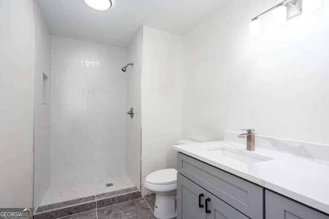 315 Henson Cir, Carrollton, GA 30117 - full bath featuring toilet, tiled shower, vanity, and tile patterned flooring