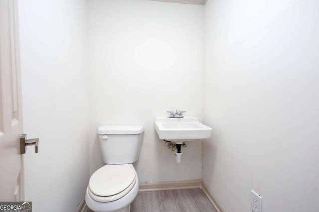 315 Henson Cir, Carrollton, GA 30117 - half bath with wood finished floors, baseboards, toilet, and a sink