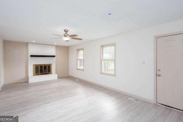 315 Henson Cir, Carrollton, GA 30117 - unfurnished living room featuring wood finished floors, a ceiling fan, baseboards, and a brick fireplace