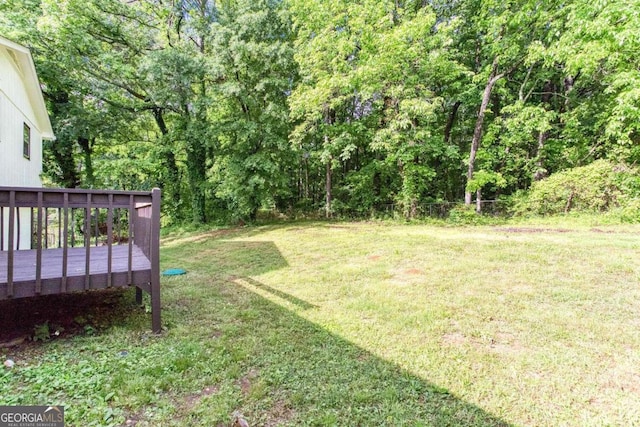 315 Henson Cir, Carrollton, GA 30117 - view of grassy yard with a deck and a forest view