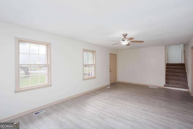 315 Henson Cir, Carrollton, GA 30117 - unfurnished living room with plenty of natural light, wood finished floors, and stairs
