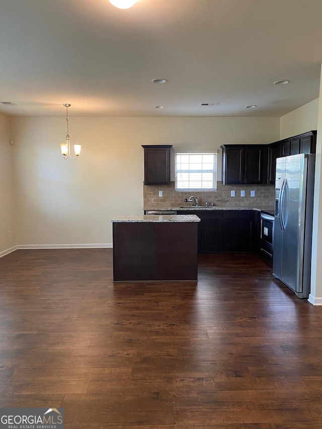 11813 Lovejoy Crossing Blvd, Hampton, GA 30228 - kitchen with stainless steel refrigerator with ice dispenser, a sink, dark wood-style flooring, tasteful backsplash, and a kitchen island