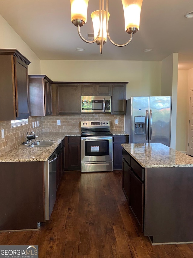 11813 Lovejoy Crossing Blvd, Hampton, GA 30228 - kitchen featuring appliances with stainless steel finishes, a sink, dark wood finished floors, dark brown cabinets, and backsplash