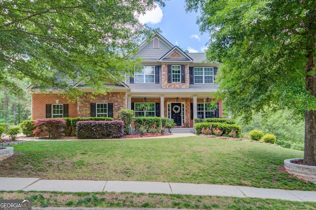 5960 Bridge Stone Ct, Cumming, GA 30028 - craftsman-style house featuring a front lawn, stone siding, and covered porch