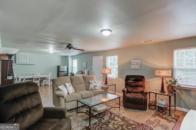 5960 Bridge Stone Ct, Cumming, GA 30028 - living room with a ceiling fan, wood finished floors, and baseboards