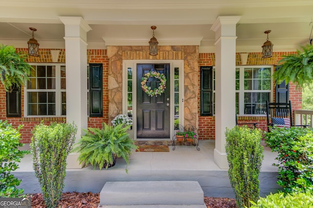 5960 Bridge Stone Ct, Cumming, GA 30028 - doorway to property featuring a porch and brick siding
