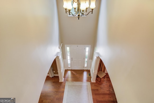 5960 Bridge Stone Ct, Cumming, GA 30028 - entryway with a chandelier, dark wood-style flooring, and a towering ceiling