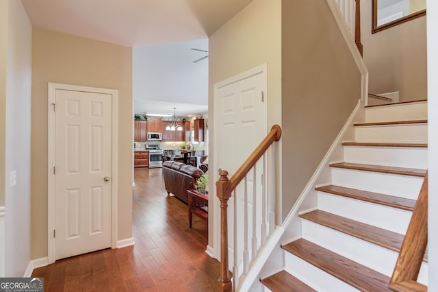 5960 Bridge Stone Ct, Cumming, GA 30028 - staircase featuring wood finished floors and a chandelier