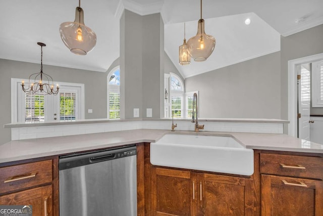 kitchen with dishwasher, a sink, vaulted ceiling, brown cabinetry, and a chandelier