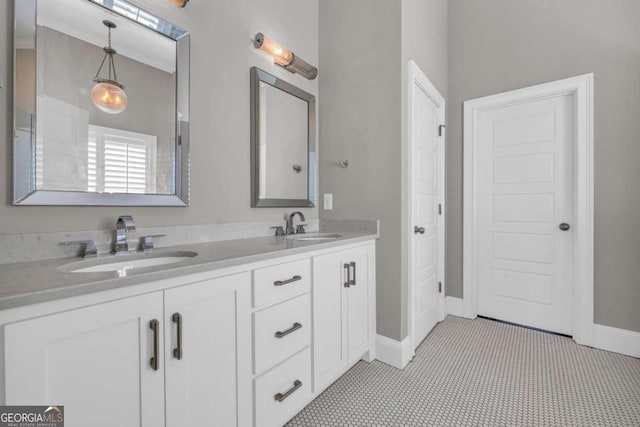 full bathroom featuring double vanity and baseboards
