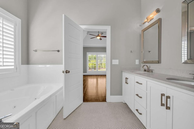 bathroom featuring ceiling fan, a whirlpool tub, and double vanity